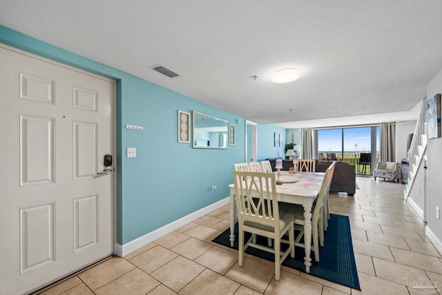 dining area featuring visible vents, baseboards, and light tile patterned flooring