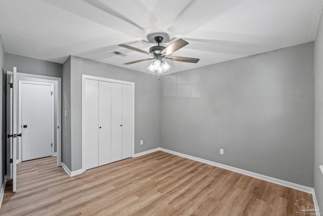 unfurnished bedroom with baseboards, visible vents, and light wood-type flooring