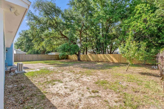 view of yard featuring a patio, a fenced backyard, and central air condition unit