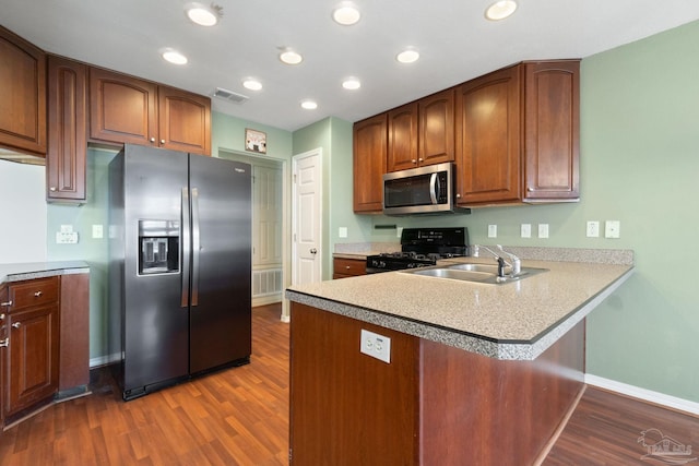 kitchen featuring sink, fridge with ice dispenser, dark hardwood / wood-style floors, and black gas range oven