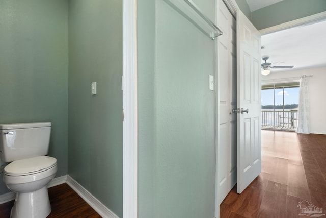 bathroom featuring ceiling fan, wood-type flooring, and toilet