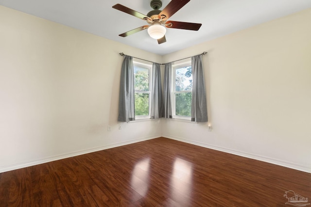 spare room with hardwood / wood-style flooring and ceiling fan