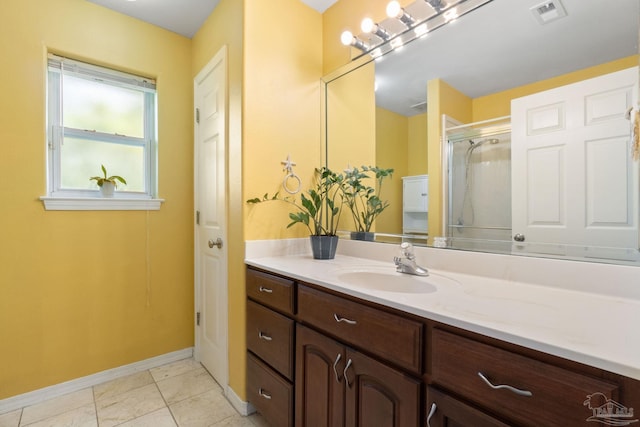 bathroom featuring walk in shower, vanity, and tile patterned flooring