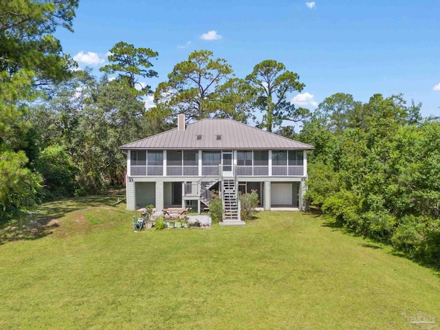 back of house with a sunroom and a yard