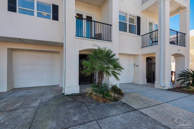 view of property with a garage and a balcony