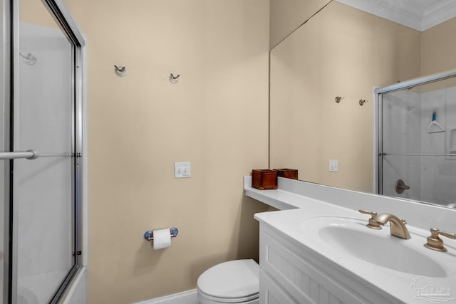 bathroom featuring toilet, vanity, and ornamental molding