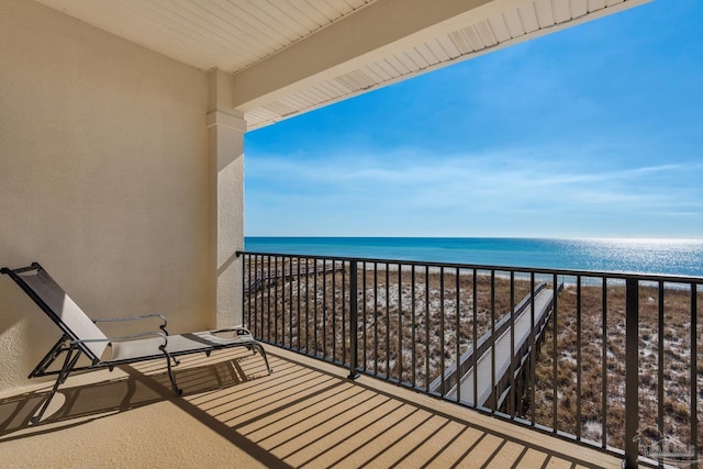 balcony featuring a water view and a view of the beach