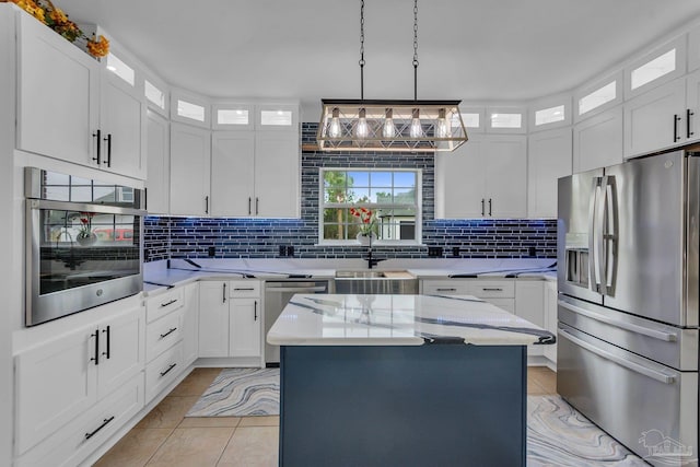 kitchen with white cabinetry, appliances with stainless steel finishes, and a kitchen island