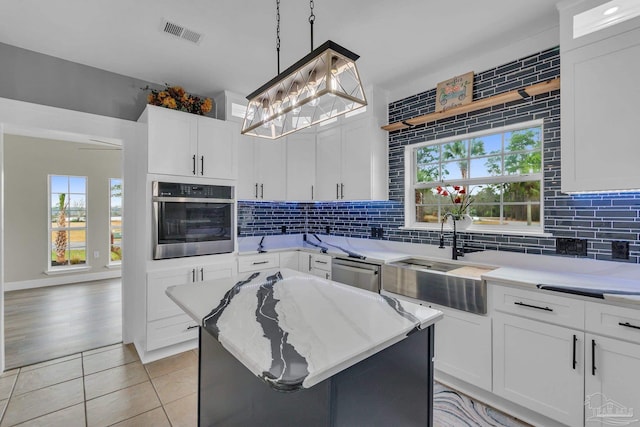 kitchen featuring a center island, white cabinets, and appliances with stainless steel finishes