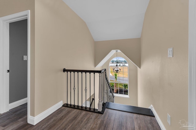 staircase with vaulted ceiling and hardwood / wood-style floors