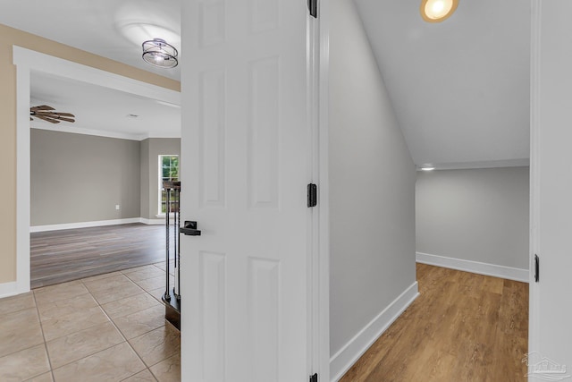 hallway featuring lofted ceiling and light hardwood / wood-style flooring