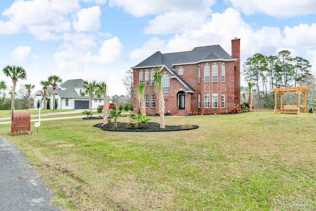 view of front of property with a front yard and a pergola