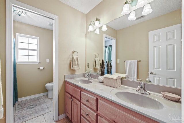 bathroom featuring tile patterned flooring, visible vents, a sink, and toilet