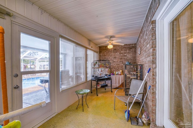 sunroom featuring a ceiling fan