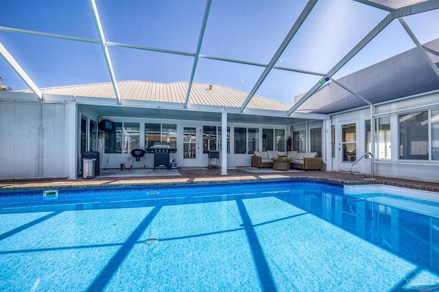 outdoor pool featuring an outdoor hangout area, glass enclosure, a patio, and grilling area