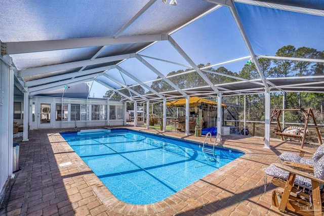 pool with a lanai and a patio area