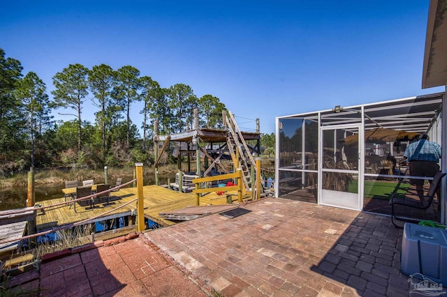 view of patio / terrace with glass enclosure and a dock