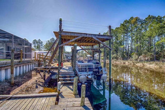 dock area with a water view and boat lift