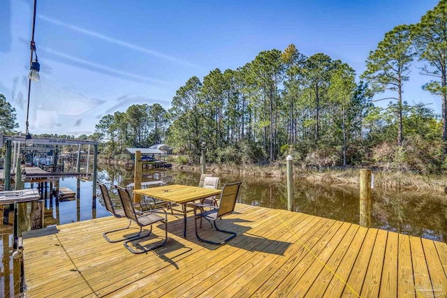 dock area with a water view and boat lift