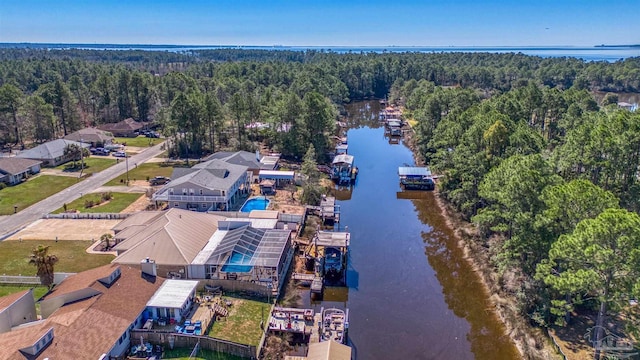 birds eye view of property featuring a water view and a forest view