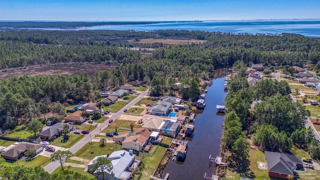 aerial view featuring a water view, a residential view, and a view of trees