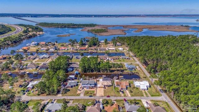 birds eye view of property with a water view and a residential view