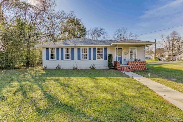 ranch-style home with covered porch and a front yard