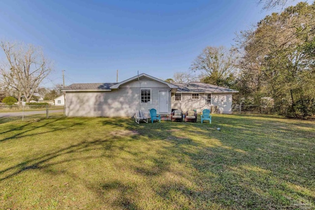 back of house with a yard and fence