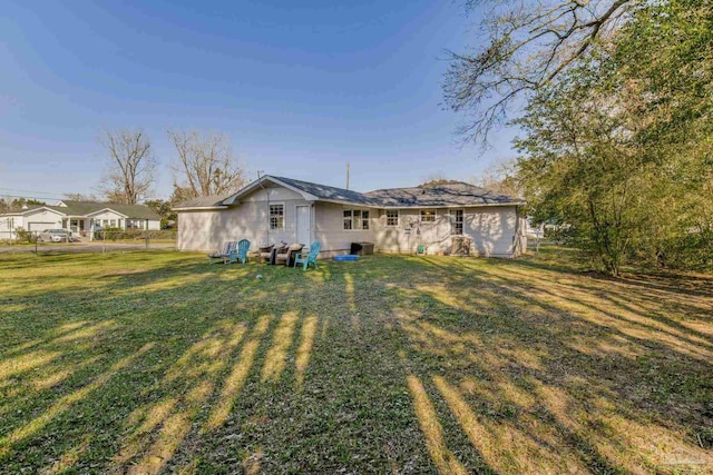 rear view of property featuring a yard