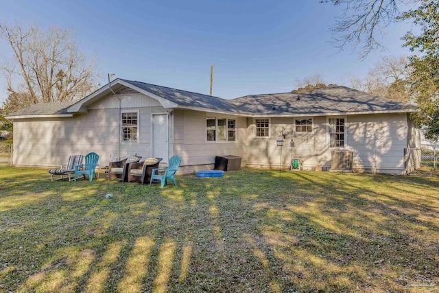 rear view of property with a lawn