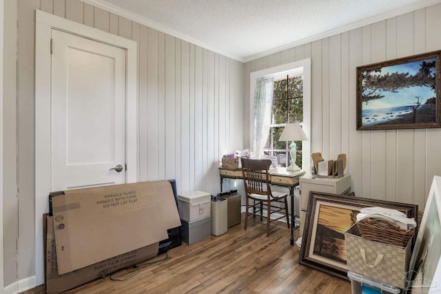 home office featuring crown molding, a textured ceiling, and hardwood / wood-style floors