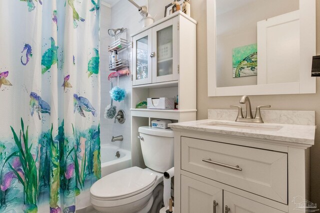 full bath with toilet, shower / bath combo with shower curtain, and vanity