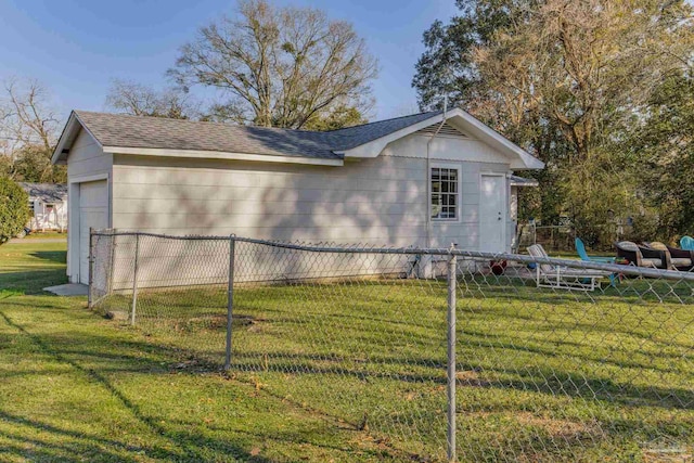 view of home's exterior featuring roof with shingles, a yard, and fence