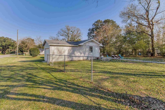 view of property exterior with fence and a yard