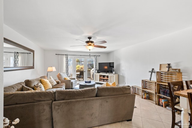 tiled living room featuring ceiling fan and french doors