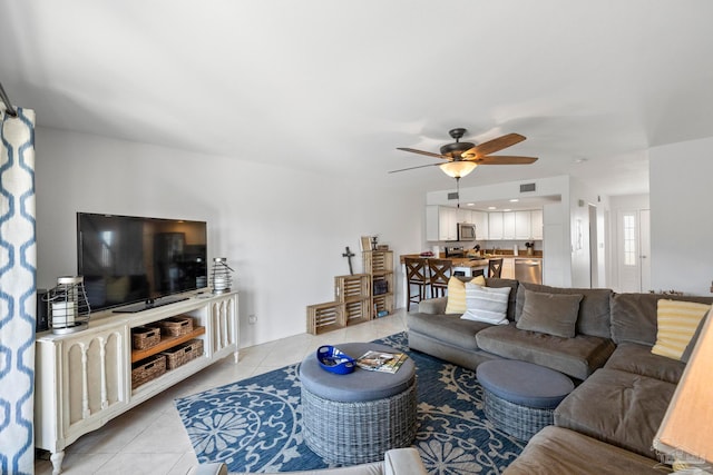 tiled living room with ceiling fan