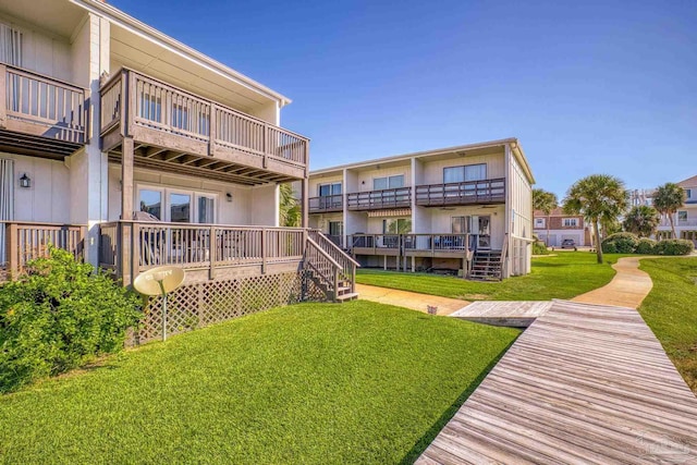 back of house featuring a yard and a wooden deck