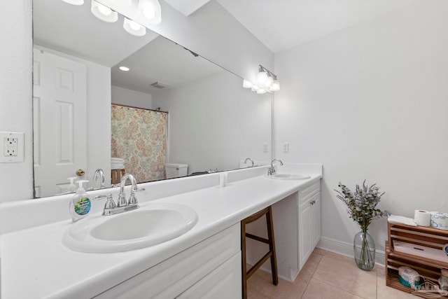 bathroom featuring tile patterned floors, vanity, and toilet