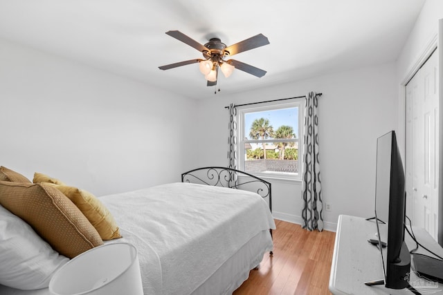 bedroom with ceiling fan, a closet, and light wood-type flooring