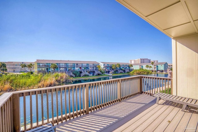 wooden terrace featuring a water view