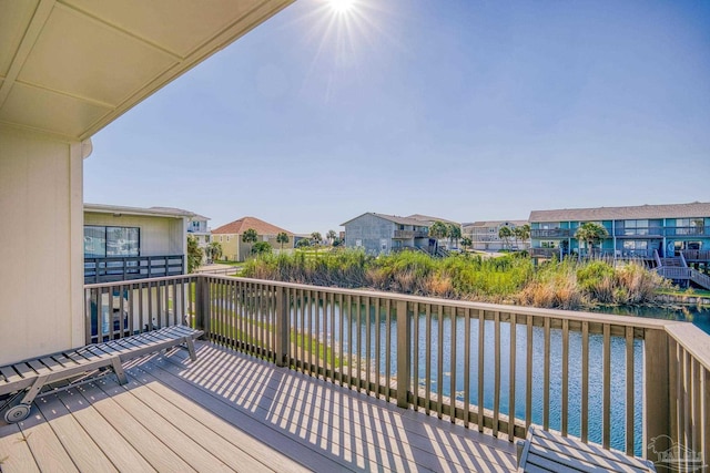 wooden terrace featuring a water view