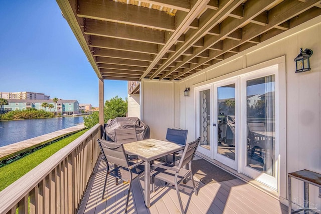 balcony featuring a water view and area for grilling