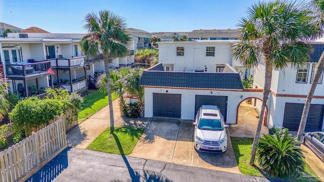 view of front of property with a balcony and a garage