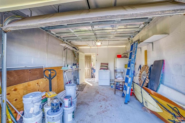 garage featuring a garage door opener and washer / dryer