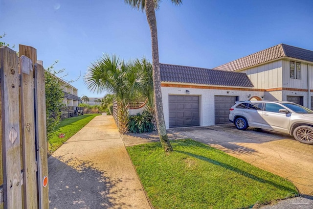 view of property exterior with a lawn and a garage