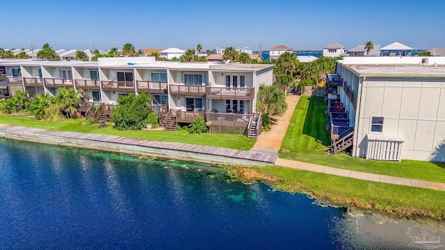 exterior space featuring a yard and a water view