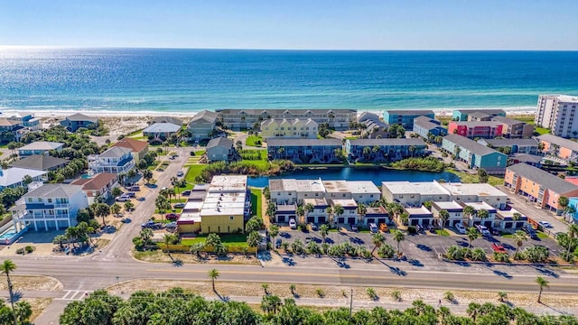 aerial view with a water view and a beach view