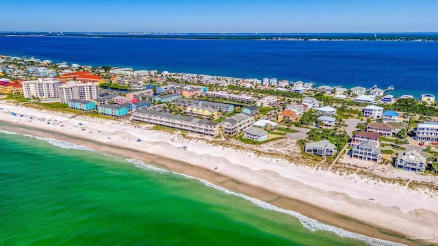 drone / aerial view with a beach view and a water view