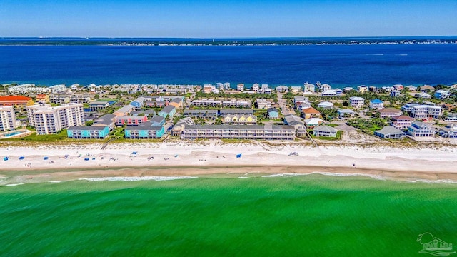 birds eye view of property with a water view and a beach view