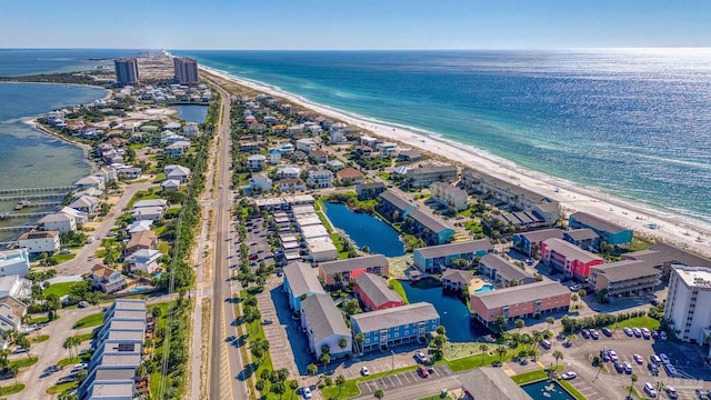 birds eye view of property with a water view and a view of the beach